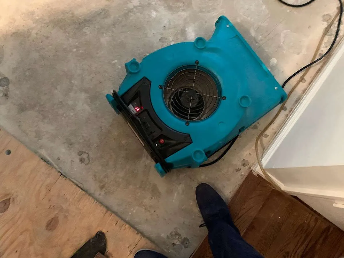 Air mover drying subfloor during Leak Detection & Repair in Oshkosh